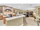 Kitchen boasts an arched brick feature over the stovetop, a breakfast bar, and views of the living room at 18328 Treehaven Dr, Hudson, FL 34667