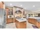 Gourmet kitchen featuring custom cabinets, a center island, and stone backsplash at 18328 Treehaven Dr, Hudson, FL 34667