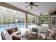 Beautiful lanai with comfortable seating and dining area overlooking the screened-in pool at 18328 Treehaven Dr, Hudson, FL 34667