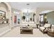Bright, neutral living room featuring a cozy seating arrangement and architectural details at 18328 Treehaven Dr, Hudson, FL 34667