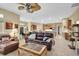 Inviting living room featuring a ceiling fan, comfortable seating, and an open floor plan with views of the kitchen at 18328 Treehaven Dr, Hudson, FL 34667