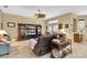 Spacious living room includes media center, ceiling fan, and sliding glass door to a screened lanai at 18328 Treehaven Dr, Hudson, FL 34667