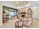 Cozy living room featuring a fireplace and view of the outdoor swimming pool at 18328 Treehaven Dr, Hudson, FL 34667
