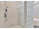 Walk-in shower with glass block wall and tiled surround at 18328 Treehaven Dr, Hudson, FL 34667