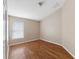 Empty bedroom with wood floors, a window with blinds, and a closet at 18456 Merseyside Loop, Land O Lakes, FL 34638