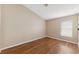An empty bedroom with wood flooring and a window allowing natural light in at 18456 Merseyside Loop, Land O Lakes, FL 34638