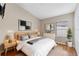 Bright bedroom featuring hardwood floors, a modern bed, and lots of natural light at 18456 Merseyside Loop, Land O Lakes, FL 34638