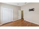 Bedroom with hardwood floors, closet, doorway and pre-installed TV mount at 18456 Merseyside Loop, Land O Lakes, FL 34638