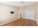 A spare bedroom featuring wood flooring, neutral paint, and a closet at 18456 Merseyside Loop, Land O Lakes, FL 34638