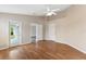A room featuring neutral walls, wood floors, and a glass-paneled door leading to a patio at 18456 Merseyside Loop, Land O Lakes, FL 34638