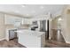 Modern kitchen with white cabinets, stainless appliances, and a central island for meal prep at 18456 Merseyside Loop, Land O Lakes, FL 34638