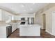 Updated kitchen with white cabinetry, quartz countertops, stainless steel appliances, and an island at 18456 Merseyside Loop, Land O Lakes, FL 34638