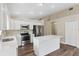 Bright kitchen featuring white cabinetry, stainless steel appliances, and an island at 18456 Merseyside Loop, Land O Lakes, FL 34638
