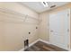 Practical laundry room with shelving, wood-look floors, and utility connections at 18456 Merseyside Loop, Land O Lakes, FL 34638