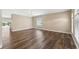 Bright living room boasts natural light, wood floors, neutral paint, and a seamless flow to adjacent spaces at 18456 Merseyside Loop, Land O Lakes, FL 34638