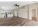 Open-concept living space with wood floors, modern kitchen, built-in desk, and neutral paint at 18456 Merseyside Loop, Land O Lakes, FL 34638
