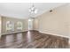 Bright and airy living room with hardwood floors, neutral paint, and a high ceiling at 18456 Merseyside Loop, Land O Lakes, FL 34638