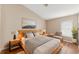 Warm, inviting main bedroom featuring a light wood frame bed and neutral decor at 18456 Merseyside Loop, Land O Lakes, FL 34638