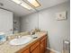 Bathroom featuring a sink, framed mirror and granite countertops at 2410 Hammock Pine Blvd # 2410, Clearwater, FL 33761