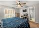 Bedroom with desk, TV, tile floors, ceiling fan, window with shutters at 2410 Hammock Pine Blvd # 2410, Clearwater, FL 33761