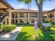 Exterior of a building with beautiful landscaping, sidewalks, and a spacious yard at 2410 Hammock Pine Blvd # 2410, Clearwater, FL 33761