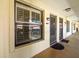 Exterior apartment hallway with window and entrances at 2410 Hammock Pine Blvd # 2410, Clearwater, FL 33761