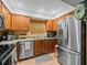 Charming kitchen with stainless steel appliances, granite countertops, and updated wooden cabinetry at 2410 Hammock Pine Blvd # 2410, Clearwater, FL 33761
