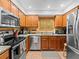 Updated kitchen with stainless steel appliances, granite countertops, and stylish wooden cabinets at 2410 Hammock Pine Blvd # 2410, Clearwater, FL 33761