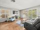 Cozy living room featuring tile floors, updated windows with blinds, and comfortable seating at 2410 Hammock Pine Blvd # 2410, Clearwater, FL 33761