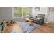 Comfortable living room with a plush sofa, area rug, and natural light from large windows at 2410 Hammock Pine Blvd # 2410, Clearwater, FL 33761
