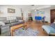 Living room with tile flooring, comfortable seating, and an open floor plan to the dining area at 2410 Hammock Pine Blvd # 2410, Clearwater, FL 33761