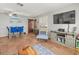 Inviting living room featuring tile floors, a dining table, and a rustic entertainment center at 2410 Hammock Pine Blvd # 2410, Clearwater, FL 33761