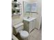 Neutral bathroom with vanity, toilet, and shelving at 24862 Us Highway 19 N # 203, Clearwater, FL 33763