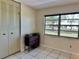 Bedroom with closet, dresser, and large window overlooking backyard at 24862 Us Highway 19 N # 203, Clearwater, FL 33763