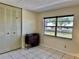 Bedroom featuring tile floors, natural light, and a closet at 24862 Us Highway 19 N # 203, Clearwater, FL 33763