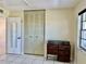 Bedroom featuring tile floors, natural light, and a closet at 24862 Us Highway 19 N # 203, Clearwater, FL 33763