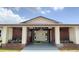 Classic club house building featuring a brick facade and covered entry with stately support columns at 24862 Us Highway 19 N # 203, Clearwater, FL 33763