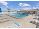 Community pool surrounded by lounge chairs, offering a perfect spot for swimming, relaxation, and socializing at 24862 Us Highway 19 N # 203, Clearwater, FL 33763
