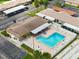 Aerial view of the community pool, surrounded by lounge chairs and lush landscaping at 24862 Us Highway 19 N # 203, Clearwater, FL 33763