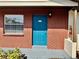 Inviting unit 203 with brick facade, a bright blue door and a conveniently located fire extinguisher at 24862 Us Highway 19 N # 203, Clearwater, FL 33763