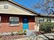 Charming brick exterior with a welcoming blue front door and well-maintained landscaping at 24862 Us Highway 19 N # 203, Clearwater, FL 33763