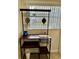 Eat-in kitchen nook featuring a rustic storage cart and ample natural light at 24862 Us Highway 19 N # 203, Clearwater, FL 33763