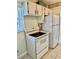 White kitchen with range, refrigerator, and window with natural light at 24862 Us Highway 19 N # 203, Clearwater, FL 33763