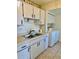 Cozy kitchen with stainless steel sink, countertops, and appliances near laundry units at 24862 Us Highway 19 N # 203, Clearwater, FL 33763