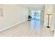 Bright, tiled living room featuring a sliding glass door with view to community at 24862 Us Highway 19 N # 203, Clearwater, FL 33763