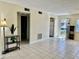 Spacious living area with tile flooring and views to the bathroom and open doorway at 24862 Us Highway 19 N # 203, Clearwater, FL 33763