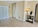 Well-lit living room with tile flooring, storage closet and sliding glass doors at 24862 Us Highway 19 N # 203, Clearwater, FL 33763