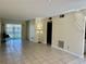 Open-concept living area with tile flooring, closet, sliding door, and neutral walls at 24862 Us Highway 19 N # 203, Clearwater, FL 33763