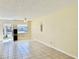 Open living room with tile floors, a ceiling fan, and natural light from the window and door at 24862 Us Highway 19 N # 203, Clearwater, FL 33763