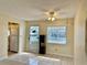 Open living area with tile flooring, a kitchen view, a ceiling fan, and natural light at 24862 Us Highway 19 N # 203, Clearwater, FL 33763